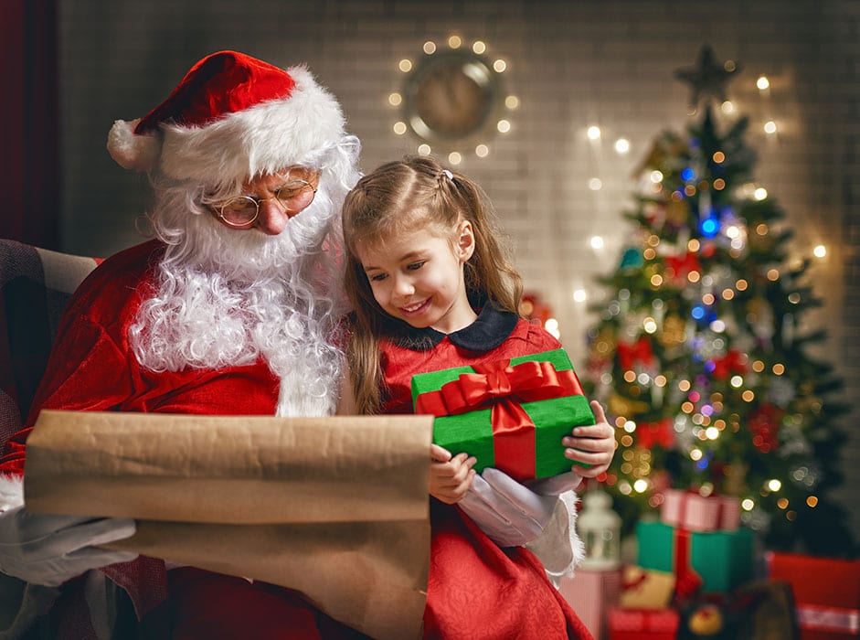 Santa Claus giving a present to a little cute girl
