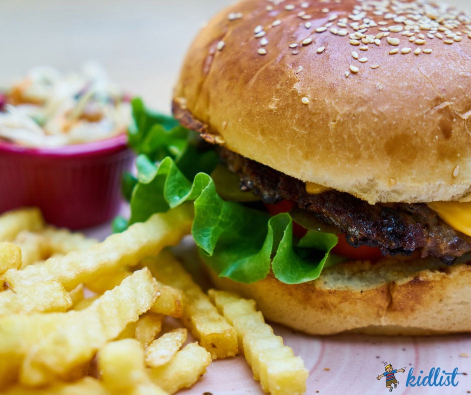 Close up of a cheeseburger and fries, showcasing one of the meals you can enjoy with kids eat free deals