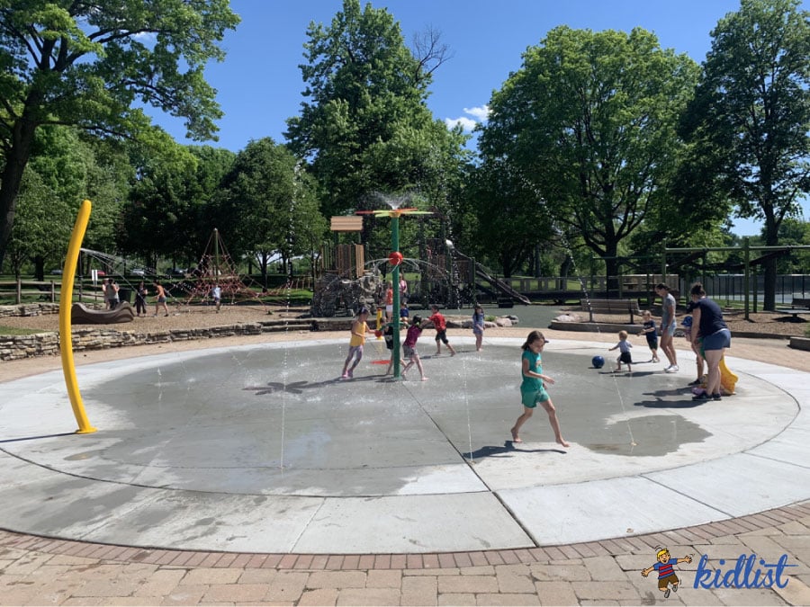 kids running through water at the Spring Rock Park splash pad in Western Springs