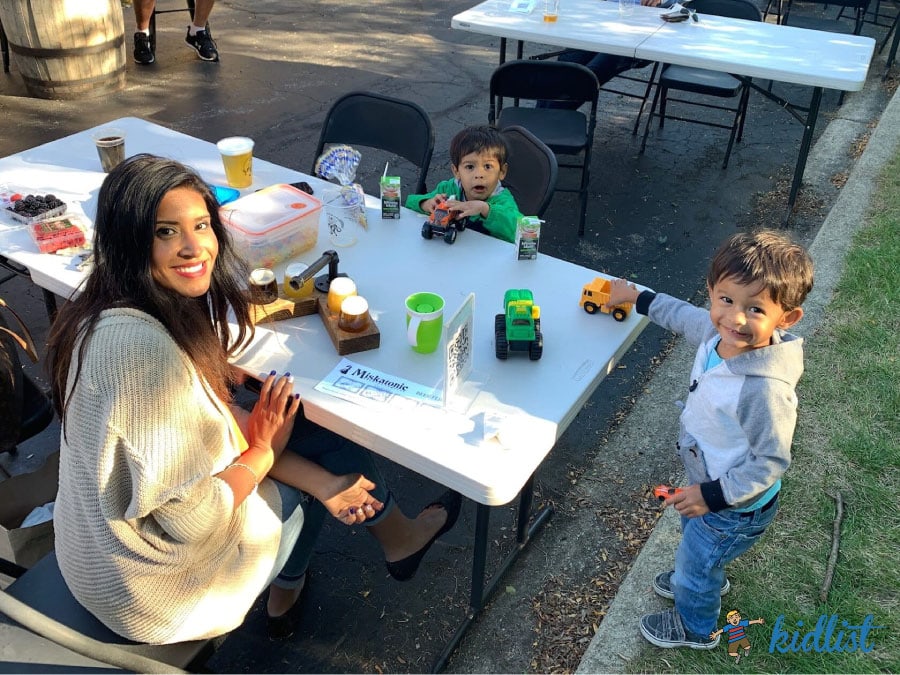A mom and her kids hanging out at one of the kid-friendly breweries playing with toys at the table