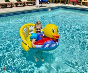 pool membership near me, little girl floating in a pool while sitting in an inflatable duck