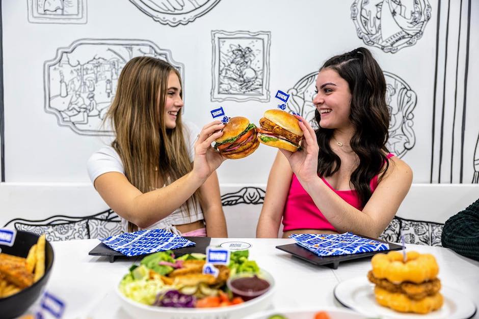 two girl toasting with hamburgers at the 2d restaurant in Chicago, photo courtesy of the restaurant's Facebook page to highlight fun restaurants for kids
