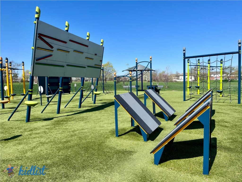 Unique obstacles and ninja park equipment on artificial turf.