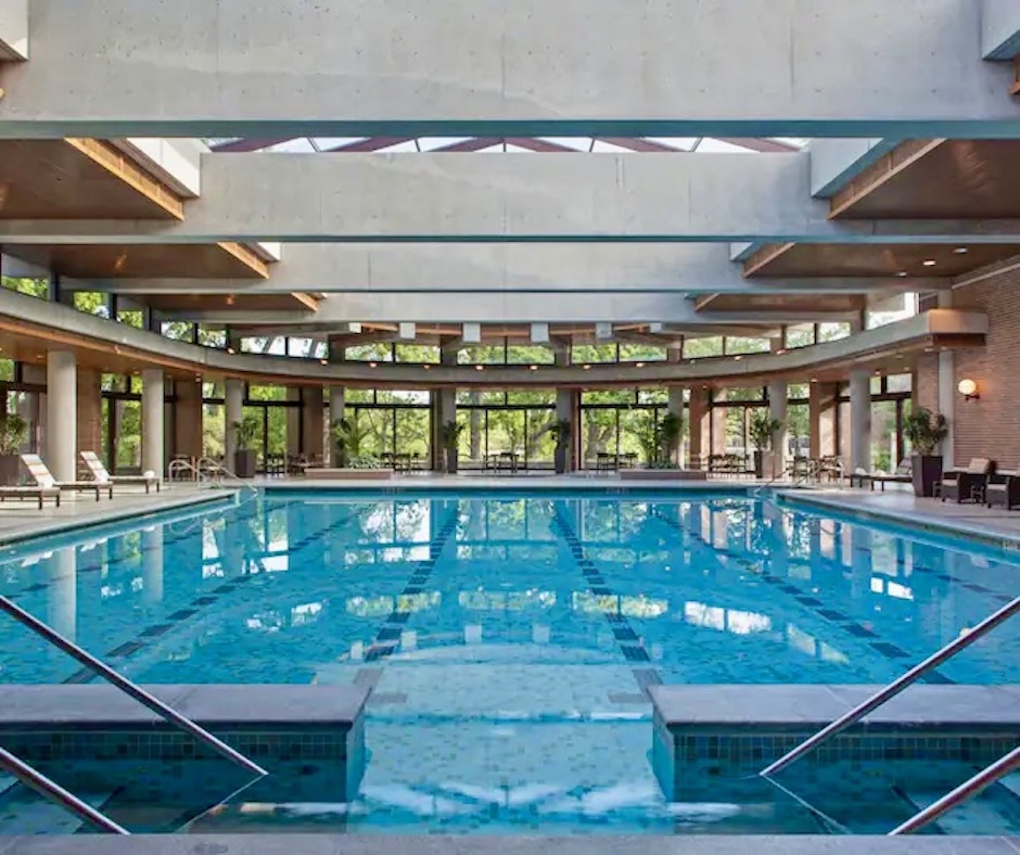 beautiful indoor swimming pool with floor to ceiling windows and a glass ceiling, adding light that reflects off the water, one of the hotels with indoor pools in the list