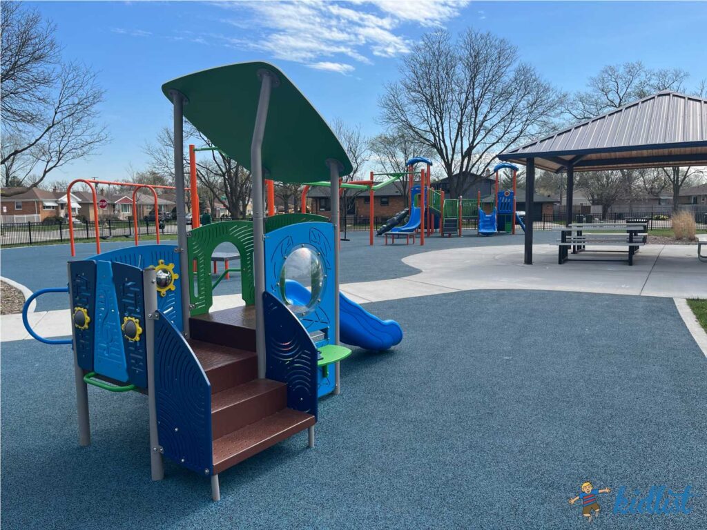 Candy Cane Park in Brookfield, with play structures for older and younger kids as well as a soft, spongy surface and a shaded pavilion with picnic tables.