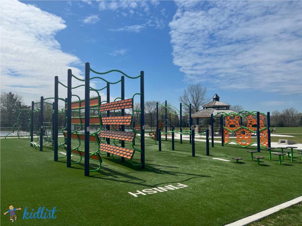 Ninja-style obstacle course on artificial turf.