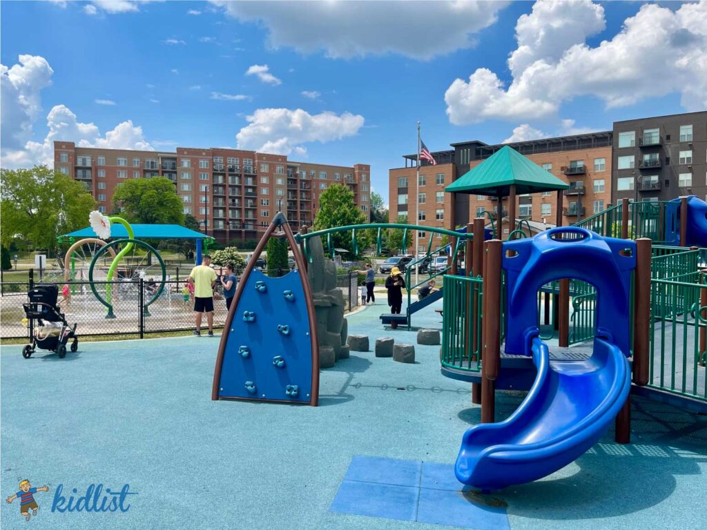 Smaller play structure for younger kids with a soft, squishy surface and gated splash pad in the background.