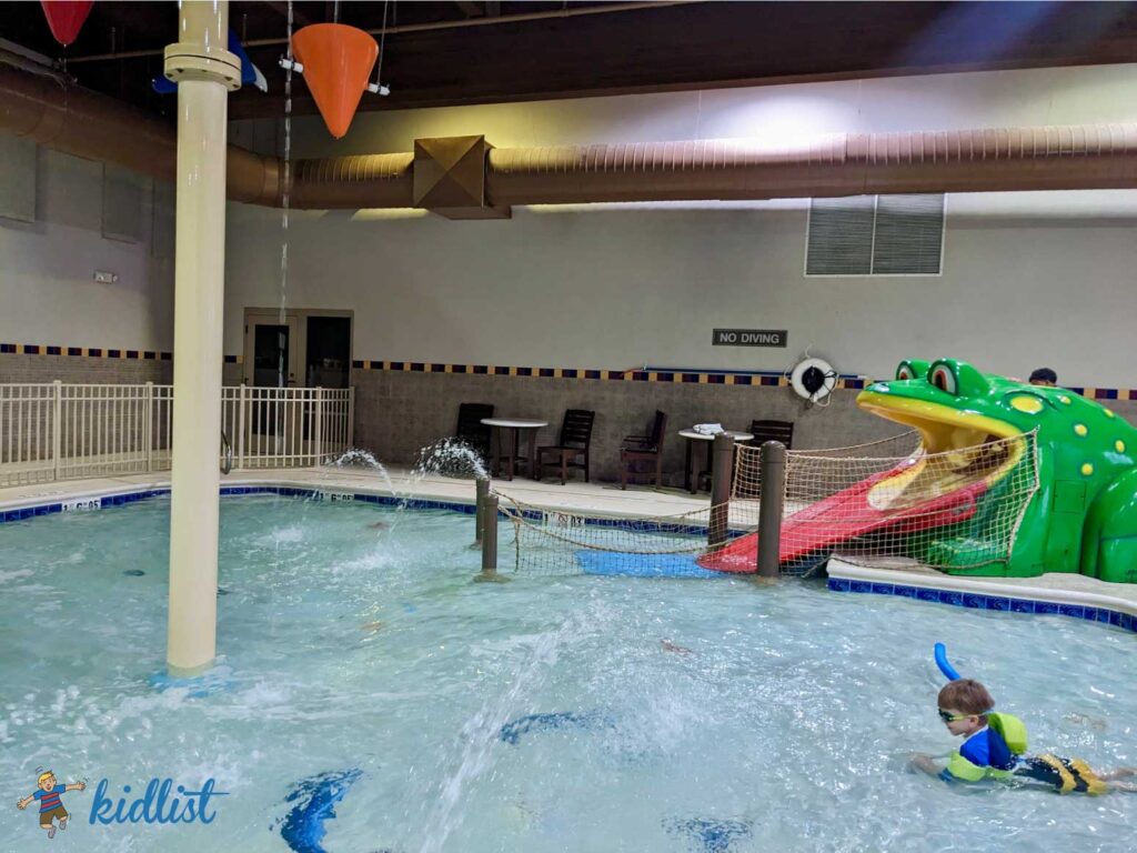 Hampton Inn & Suites Chicago in Aurora with frog slide and dumping buckets to showcase one of the hotels with indoor pools in the Chicago suburbs