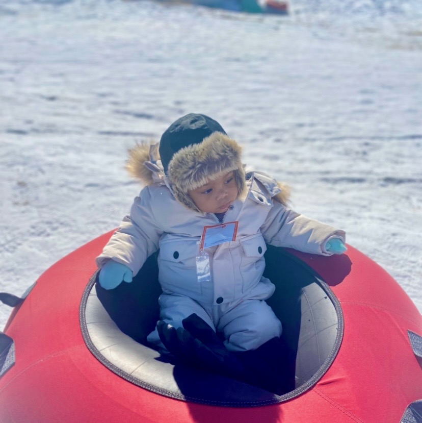 baby in a tube showing snow tubing as one of the most fun winter activities