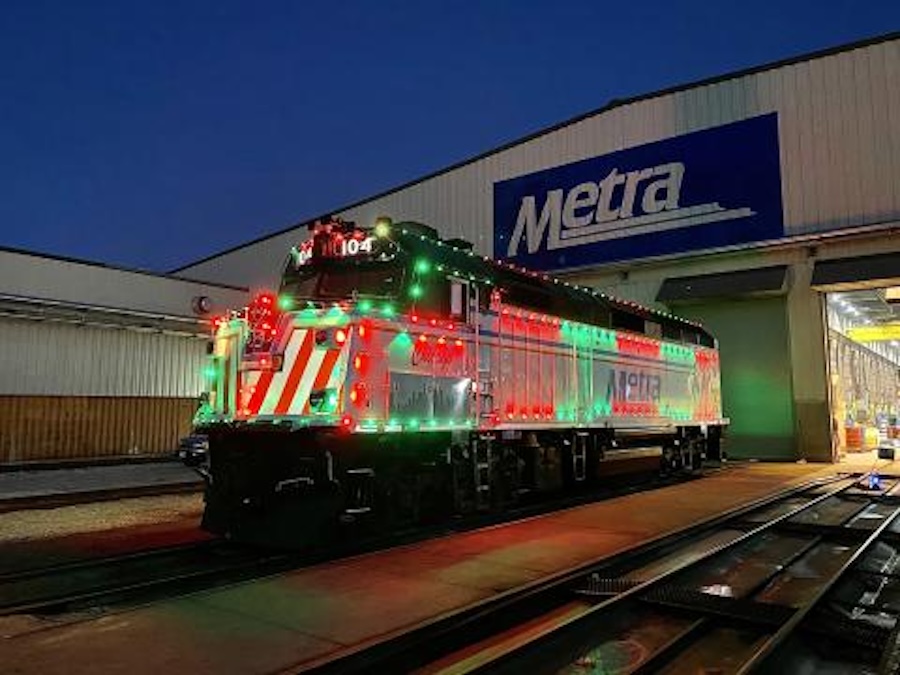 Metra train engine decorated with red and green holiday lights.