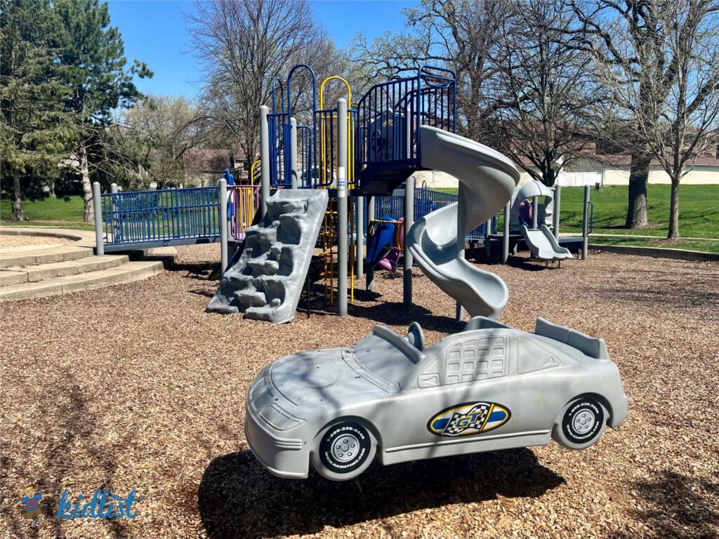 Playground and ride-on car play structure at Mending Wall Park in Woodridge.