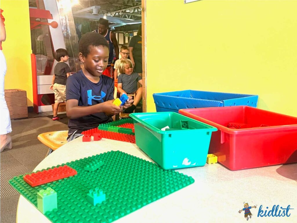 A child playing with Duplo blocks at Wonder Works Children's Museum.